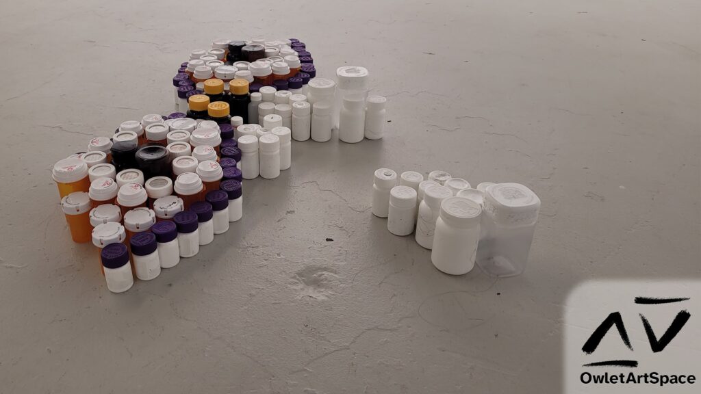 A perspective view of the first installation of the Pill Bottle Mural that shows the varying heights of the pill bottles along with the sides of the bottles.