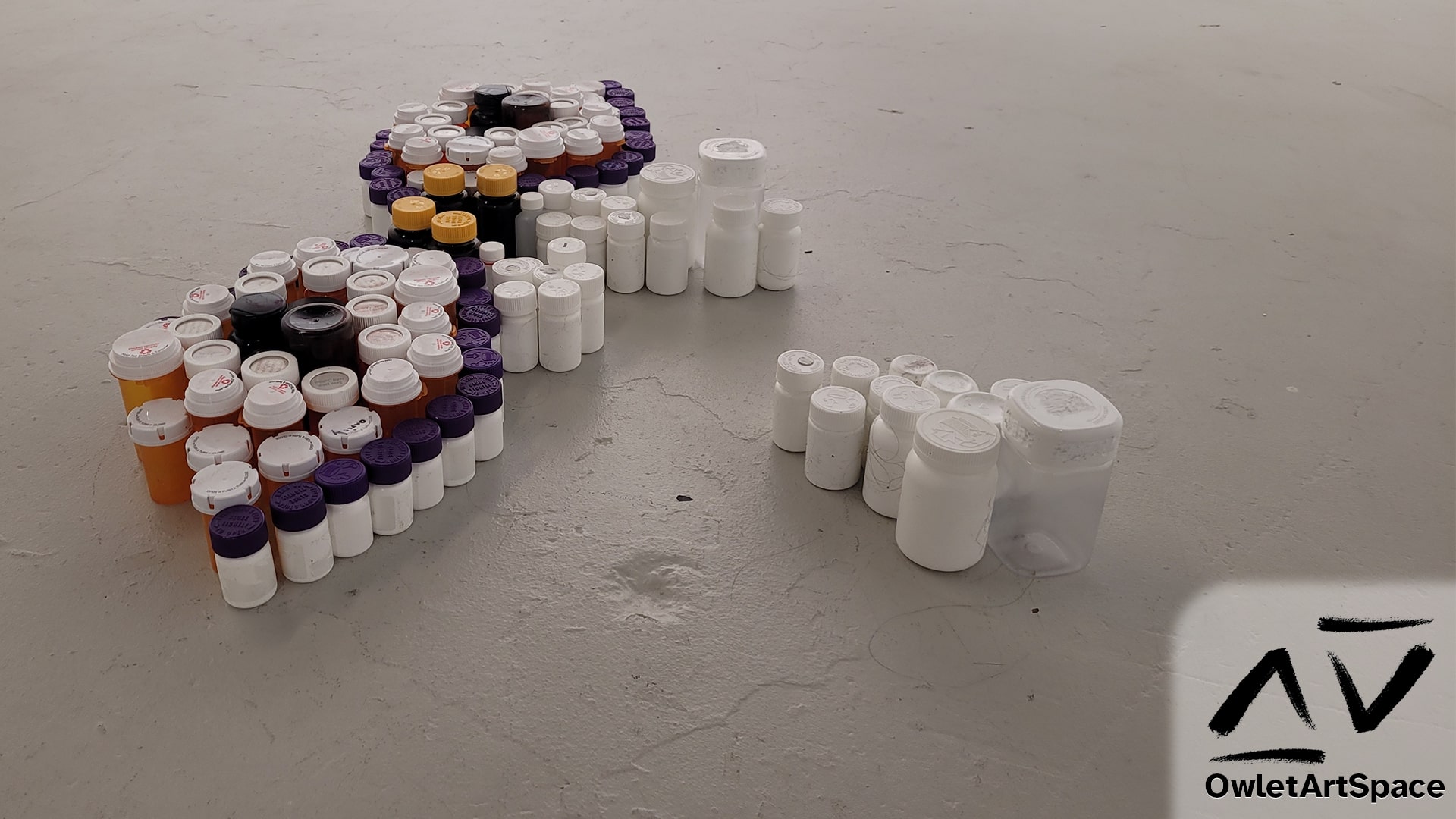 A perspective view of the Pill Bottle Mural that shows the varying heights of the pill bottles along with the sides of the bottles.