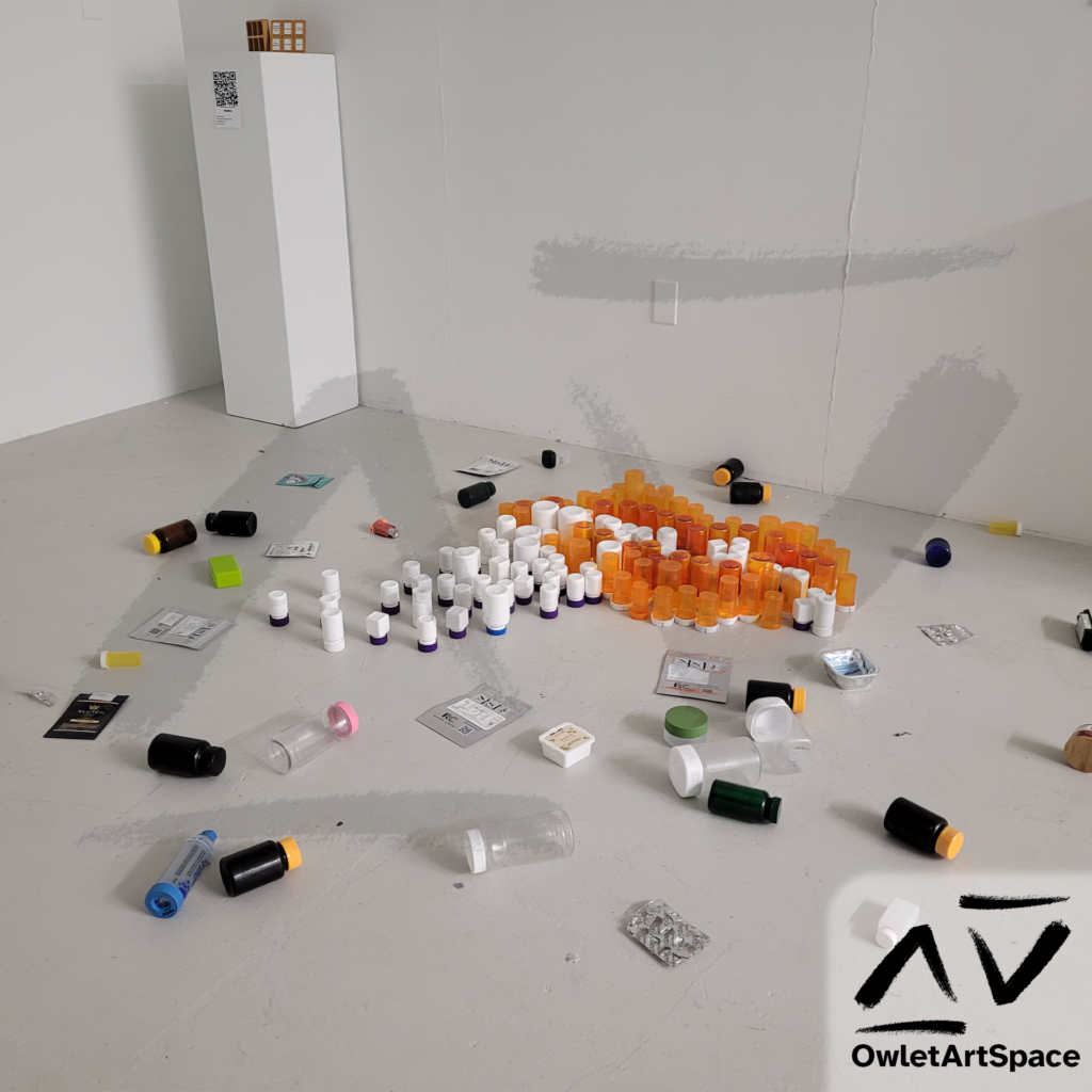 A perspective view of the second installation of the Pill Bottle Mural that shows the varying heights of the pill bottles along with the sides of the bottles that gives the lips volume.