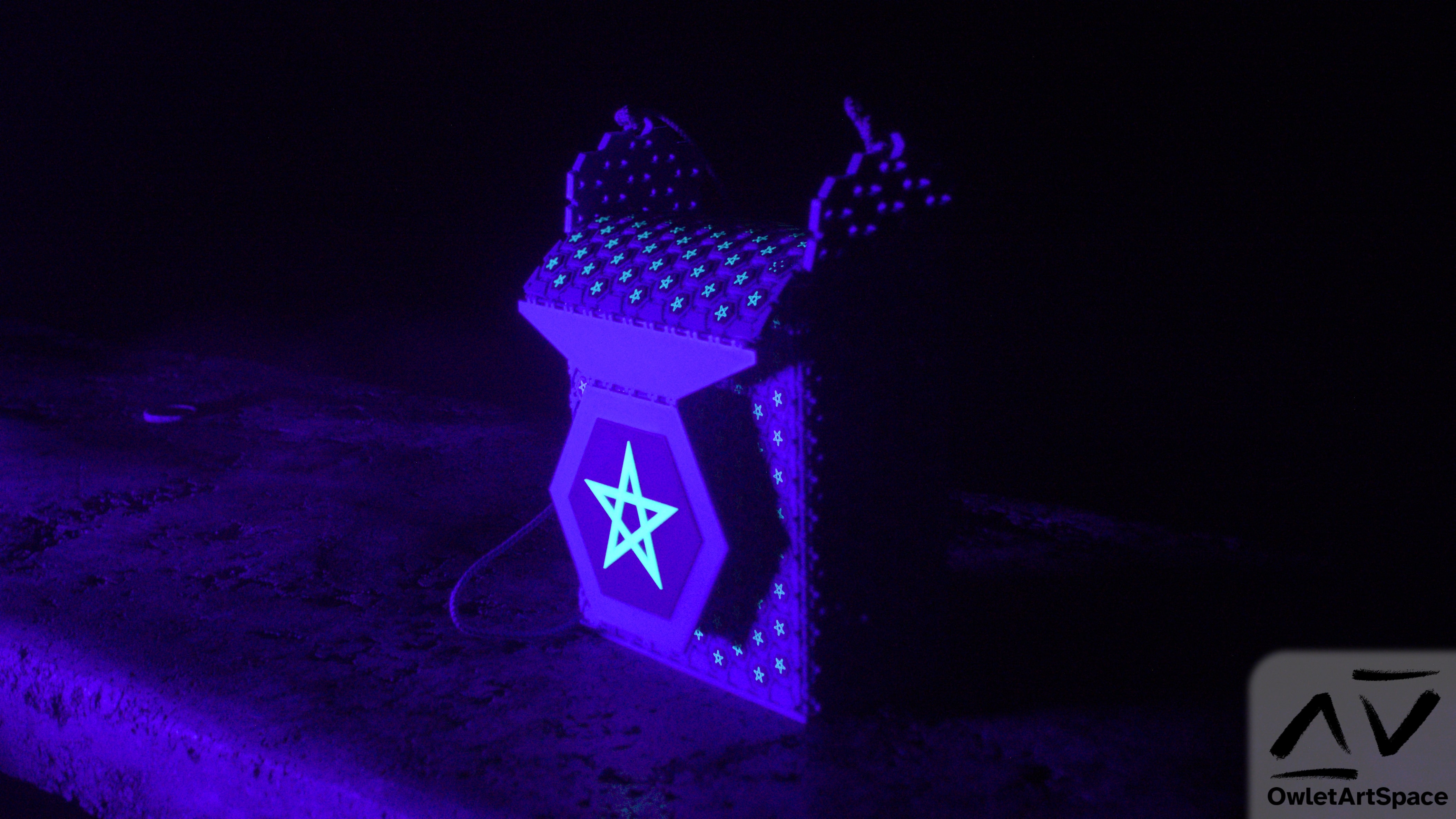 The starry bag under UV lighting. The stars have a fluorescent glow.